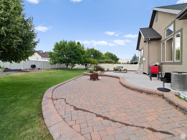 2618 W Mountain Rd, Tremonton, UT 84337 - fenced backyard with a patio and an outdoor fire pit