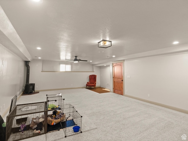 2618 W Mountain Rd, Tremonton, UT 84337 - below grade area featuring a wood stove, recessed lighting, and carpet flooring