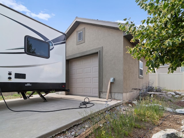 2618 W Mountain Rd, Tremonton, UT 84337 - view of side of property with stucco siding and a garage
