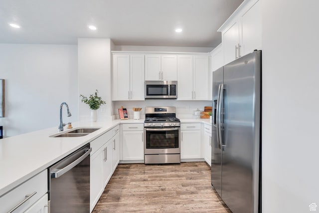 1052 W Azul Meadows Way S, Bluffdale, UT 84065 - kitchen featuring appliances with stainless steel finishes, light wood-style floors, white cabinets, light countertops, and recessed lighting