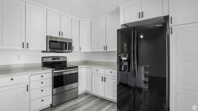 6568 S 5180 W, West Jordan, UT 84081 - kitchen featuring stainless steel appliances, white cabinets, light countertops, and light wood finished floors