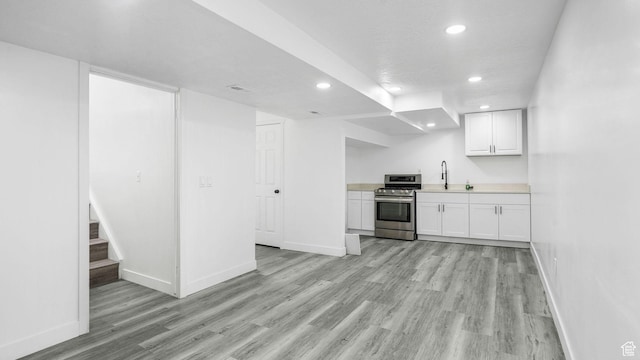6568 S 5180 W, West Jordan, UT 84081 - kitchen with stainless steel range oven, recessed lighting, light wood-type flooring, white cabinetry, and light countertops