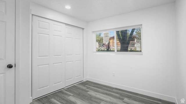 6568 S 5180 W, West Jordan, UT 84081 - unfurnished bedroom with dark wood-style flooring, a closet, and recessed lighting