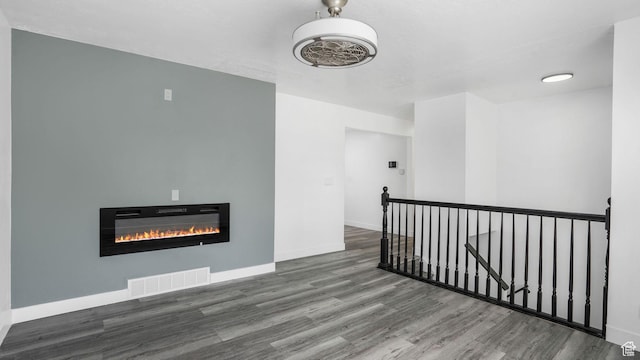 6568 S 5180 W, West Jordan, UT 84081 - unfurnished living room with wood finished floors and a glass covered fireplace