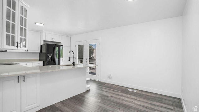 6568 S 5180 W, West Jordan, UT 84081 - kitchen featuring black fridge, glass insert cabinets, white cabinets, light countertops, and dark wood-type flooring
