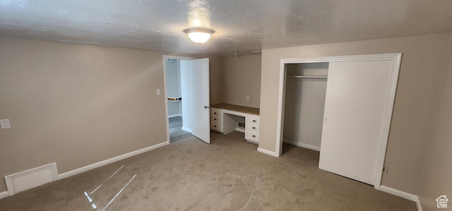 1444 S Beacon Dr E, Salt Lake City, UT 84108 - unfurnished bedroom with light carpet, a closet, and a textured ceiling