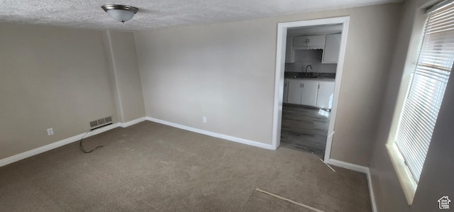 1444 S Beacon Dr E, Salt Lake City, UT 84108 - carpeted spare room featuring healthy amount of natural light and a textured ceiling
