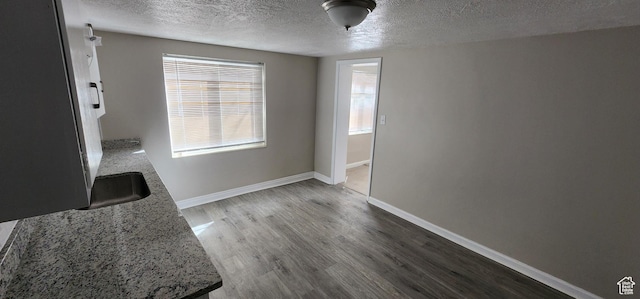 1444 S Beacon Dr E, Salt Lake City, UT 84108 - unfurnished dining area with a textured ceiling and wood finished floors