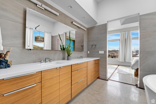 4601 N Toscana Hills Dr, Lehi, UT 84043 - full bath with a freestanding bath, concrete flooring, double vanity, and healthy amount of natural light