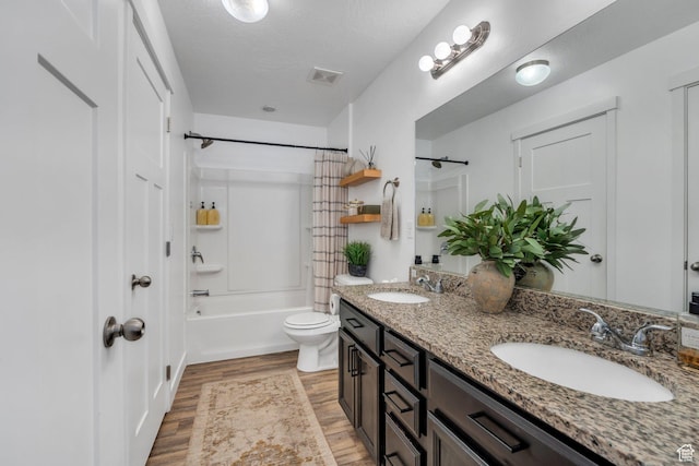 330 N 680 E Unit 330, Vineyard, UT 84059 - bathroom with double vanity, wood finished floors, shower / bath combo with shower curtain, and a textured ceiling