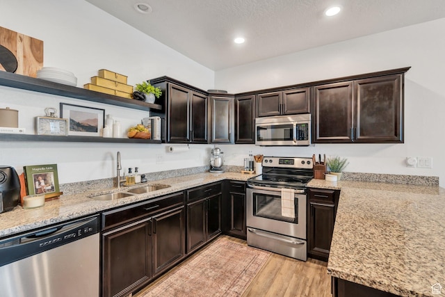 330 N 680 E Unit 330, Vineyard, UT 84059 - kitchen with open shelves, stainless steel appliances, dark brown cabinetry, light stone countertops, and recessed lighting