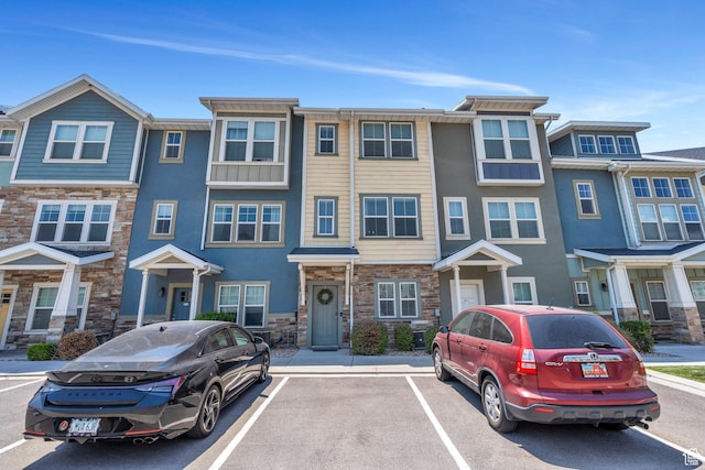 330 N 680 E Unit 330, Vineyard, UT 84059 - view of property featuring stone siding and uncovered parking