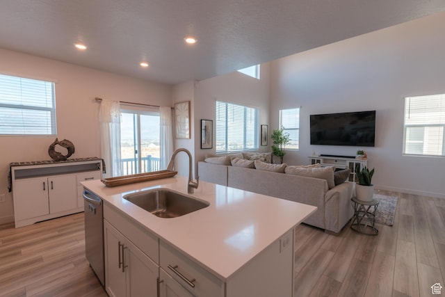 2006 N Red Yearling Dr, Saratoga Springs, UT 84045 - kitchen with light wood finished floors, open floor plan, recessed lighting, white cabinets, and an island with sink
