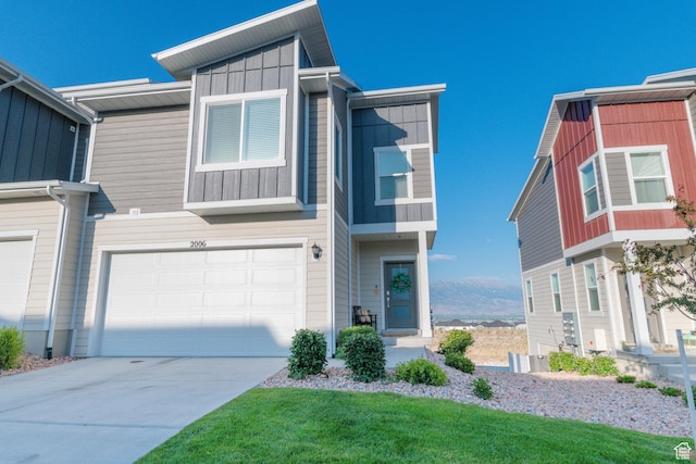 2006 N Red Yearling Dr, Saratoga Springs, UT 84045 - view of front of house featuring board and batten siding, an attached garage, and driveway