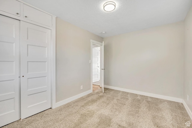 1895 E Brookhill Dr, Cottonwood Heights, UT 84121 - unfurnished bedroom featuring light colored carpet, a closet, and a textured ceiling