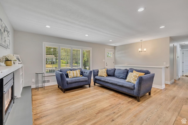 1895 E Brookhill Dr, Cottonwood Heights, UT 84121 - living room with light wood-type flooring, recessed lighting, a fireplace, and a chandelier