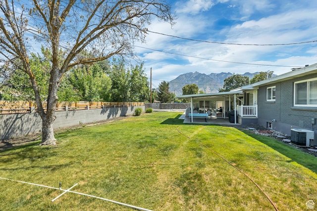 1895 E Brookhill Dr, Cottonwood Heights, UT 84121 - fenced backyard with a mountain view and a patio area