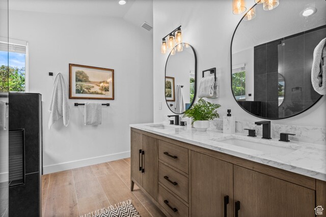 11362 S Mariposa Way E, Sandy, UT 84094 - bathroom featuring double vanity, wood finished floors, a chandelier, and lofted ceiling
