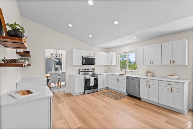 11362 S Mariposa Way E, Sandy, UT 84094 - kitchen with appliances with stainless steel finishes, light countertops, light wood-style flooring, recessed lighting, and lofted ceiling