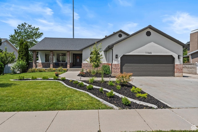 11362 S Mariposa Way E, Sandy, UT 84094 - view of front of house featuring brick siding, an attached garage, driveway, a front lawn, and covered porch