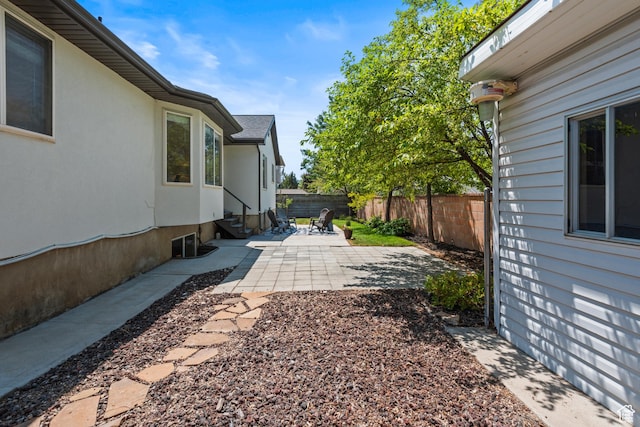 11362 S Mariposa Way E, Sandy, UT 84094 - fenced backyard featuring entry steps and a patio area