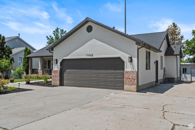 11362 S Mariposa Way E, Sandy, UT 84094 - ranch-style home featuring an attached garage, driveway, brick siding, a shingled roof, and stucco siding