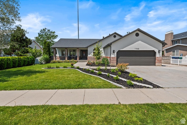 11362 S Mariposa Way E, Sandy, UT 84094 - view of front of house featuring an attached garage, driveway, a porch, and brick siding