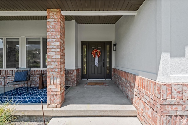 11362 S Mariposa Way E, Sandy, UT 84094 - property entrance featuring covered porch, brick siding, and stucco siding