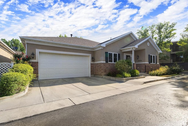 4470 S Snowmass Ct, Millcreek, UT 84124 - single story home featuring brick siding, stucco siding, driveway, and a garage