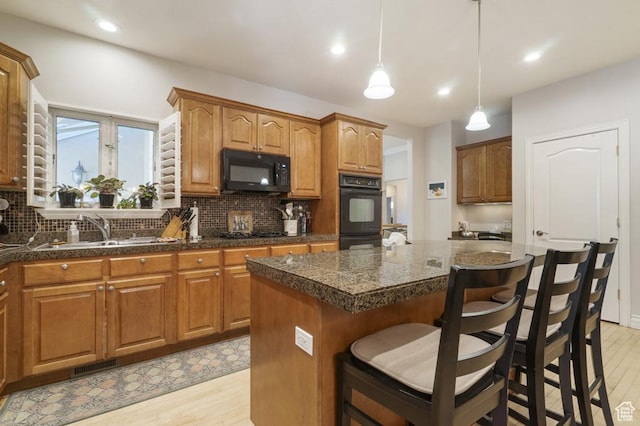 4470 S Snowmass Ct, Millcreek, UT 84124 - kitchen featuring black appliances, light wood finished floors, a center island, backsplash, and recessed lighting