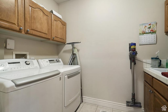 4470 S Snowmass Ct, Millcreek, UT 84124 - laundry room with washing machine and clothes dryer, cabinet space, and light tile patterned flooring