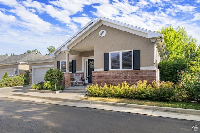 4470 S Snowmass Ct, Millcreek, UT 84124 - view of front of house with a garage, stucco siding, and brick siding