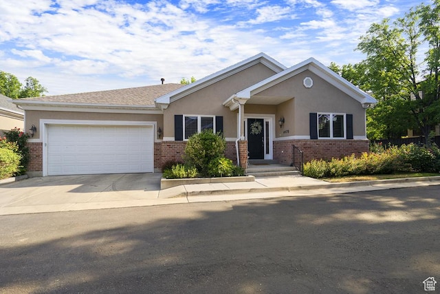 4470 S Snowmass Ct, Millcreek, UT 84124 - view of front of house featuring stucco siding, brick siding, a garage, and concrete driveway