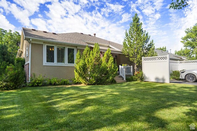 4470 S Snowmass Ct, Millcreek, UT 84124 - rear view of house with stucco siding and a shingled roof