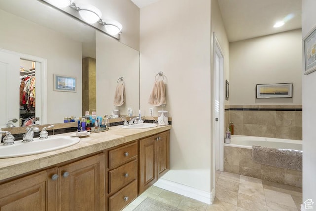 4470 S Snowmass Ct, Millcreek, UT 84124 - full bathroom with double vanity, tiled tub, tile patterned floors, and a walk in closet