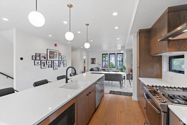 537 S 500 E Unit 106, Salt Lake City, UT 84102 - kitchen featuring appliances with stainless steel finishes, light wood finished floors, recessed lighting, light countertops, and open floor plan