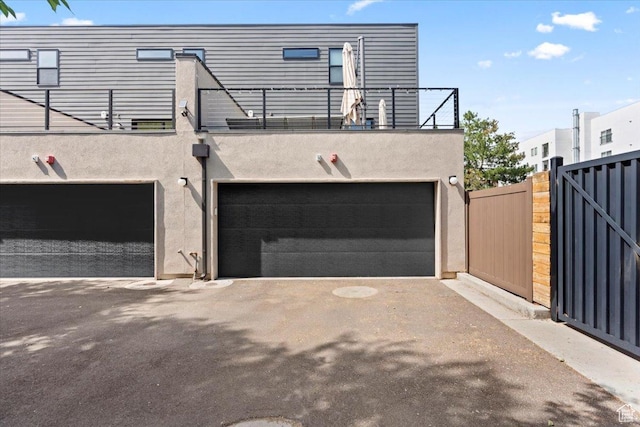 537 S 500 E Unit 106, Salt Lake City, UT 84102 - rear view of property with stucco siding, a balcony, and a garage