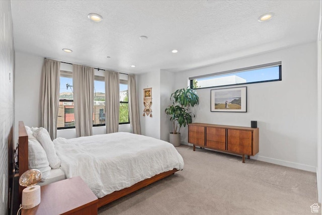 537 S 500 E Unit 106, Salt Lake City, UT 84102 - bedroom featuring multiple windows, light colored carpet, recessed lighting, and a textured ceiling