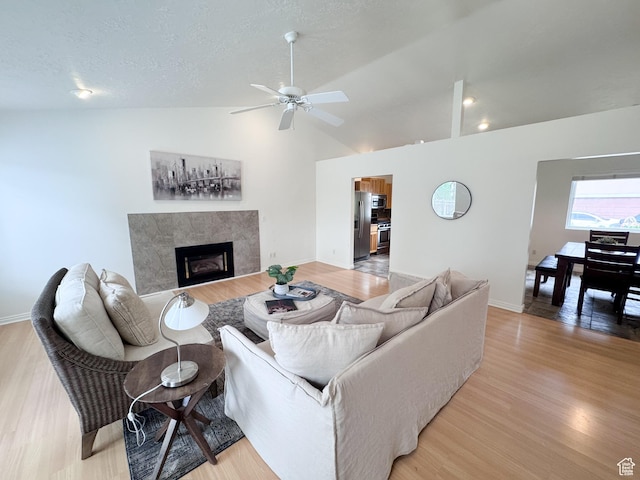 841 E 8600 S, Sandy, UT 84094 - living area featuring light wood-style floors, ceiling fan, a fireplace, and vaulted ceiling