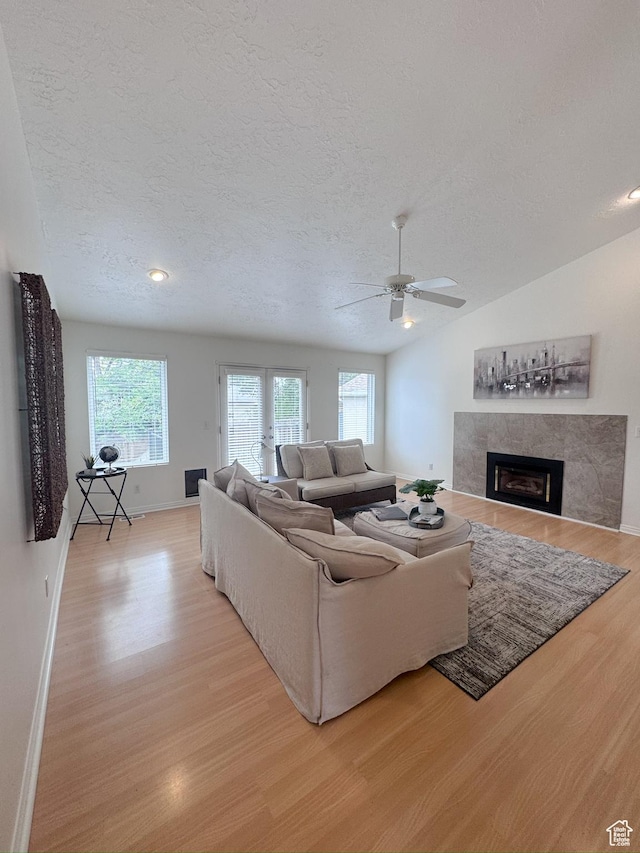 841 E 8600 S, Sandy, UT 84094 - living area featuring a textured ceiling, light wood-style floors, a fireplace, and a ceiling fan
