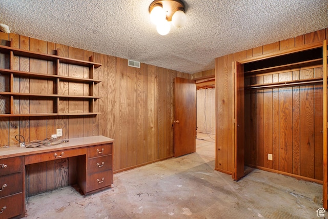 451 S 800 E, Orem, UT 84097 - unfurnished office featuring wood walls, a textured ceiling, unfinished concrete flooring, and built in study area