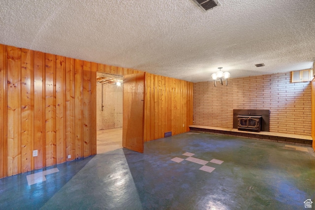451 S 800 E, Orem, UT 84097 - below grade area with a wood stove, wooden walls, and a textured ceiling