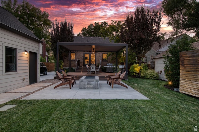 1127 S Denver St S, Salt Lake City, UT 84111 - patio terrace at dusk featuring a patio area, a yard, a grill, and an outdoor fire pit
