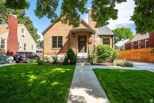 1127 S Denver St S, Salt Lake City, UT 84111 - view of front of house with brick siding, a chimney, and roof with shingles