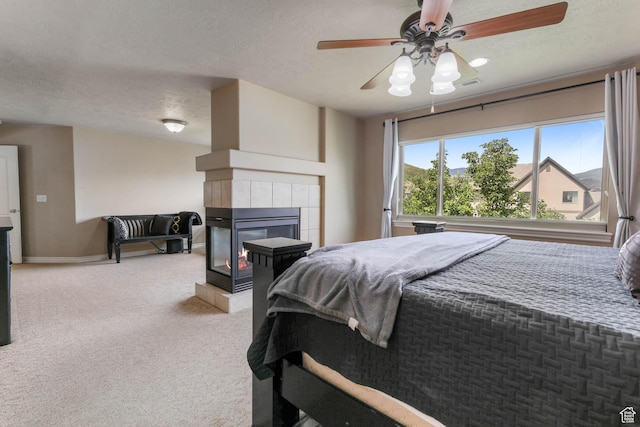 14346 S Fort Duchesne Cv, Herriman, UT 84096 - bedroom featuring a textured ceiling, light carpet, a fireplace, and ceiling fan