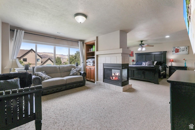 14346 S Fort Duchesne Cv, Herriman, UT 84096 - carpeted living room featuring a fireplace, a textured ceiling, and a ceiling fan