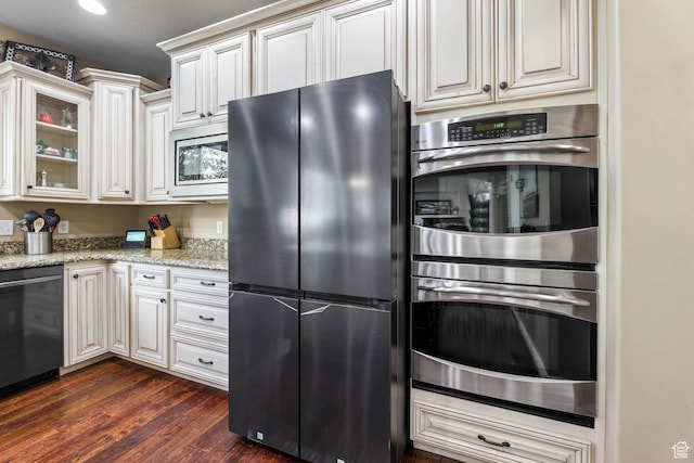 14346 S Fort Duchesne Cv, Herriman, UT 84096 - kitchen with stainless steel appliances, dark wood-style floors, light stone countertops, glass insert cabinets, and white cabinetry