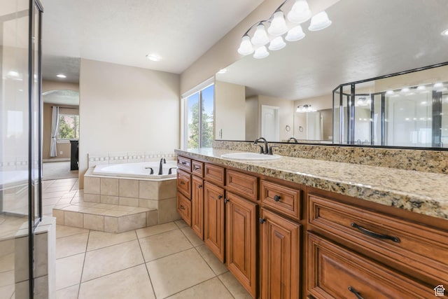 14346 S Fort Duchesne Cv, Herriman, UT 84096 - full bathroom with vanity, a garden tub, plenty of natural light, and tile patterned floors