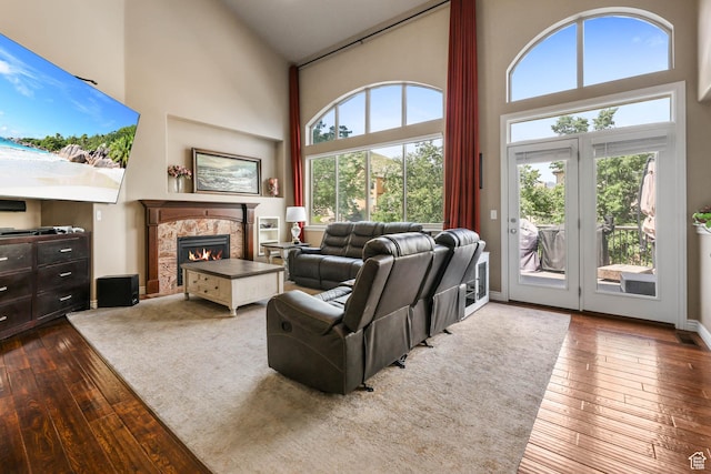 14346 S Fort Duchesne Cv, Herriman, UT 84096 - living room with high vaulted ceiling, dark wood-style flooring, plenty of natural light, and a fireplace
