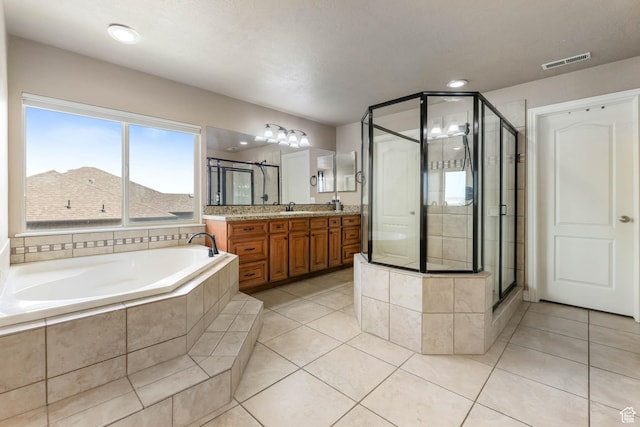 14346 S Fort Duchesne Cv, Herriman, UT 84096 - bathroom with vanity, a garden tub, tile patterned flooring, and a shower stall